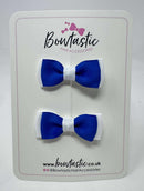Two blue and white hair bows on a 'Bowtastic' branded card.