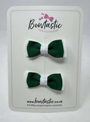 Two green and white hair bows on a 'Boutastic' branded card.